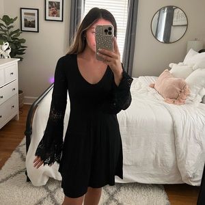 Black express dress, with bell sleeves, and lace detailing on the sleeves